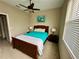 Bedroom with queen bed and ceiling fan at 24479 Vienison Ln, Punta Gorda, FL 33955