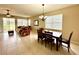 Spacious dining area with a large table and chairs, adjacent to living room at 24479 Vienison Ln, Punta Gorda, FL 33955