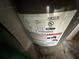 Electric water heater with safety labels and specifications at 24479 Vienison Ln, Punta Gorda, FL 33955