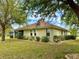 House exterior view, showcasing landscaping and backyard at 24479 Vienison Ln, Punta Gorda, FL 33955