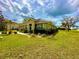 House exterior with manicured lawn and landscaping at 24479 Vienison Ln, Punta Gorda, FL 33955