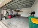 Two-car garage with overhead storage and waste bins at 24479 Vienison Ln, Punta Gorda, FL 33955