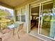 Screened porch with patio furniture and view of backyard at 24479 Vienison Ln, Punta Gorda, FL 33955