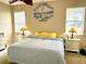 Main bedroom with king-size bed, striped bedding and two nightstands at 24479 Vienison Ln, Punta Gorda, FL 33955