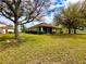 House exterior showcasing landscaping and backyard view at 24479 Vienison Ln, Punta Gorda, FL 33955