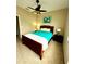 Bright bedroom with double bed, nightstands, and ceiling fan at 24479 Vienison Ln, Punta Gorda, FL 33955