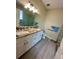 Updated bathroom with granite vanity, double sinks, and large walk-in shower at 24479 Vienison Ln, Punta Gorda, FL 33955