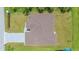 Overhead view of a house showing a brown roof and a gray paved driveway at 1863 Waldorf Dr, North Port, FL 34288