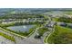 Aerial view of community featuring homes,lake, and lush landscaping at 17130 Jadestone Ct, Venice, FL 34293