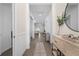 Bright and airy entryway with wood-look floors and stylish console table at 17130 Jadestone Ct, Venice, FL 34293