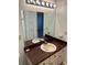 Bathroom vanity with brown countertop, single sink, and large mirror at 3303 Ithaca St, Port Charlotte, FL 33952
