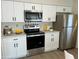Modern kitchen with white cabinets and stainless steel appliances at 3303 Ithaca St, Port Charlotte, FL 33952
