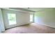 Spacious bedroom with neutral carpeting and large windows at 174 Aurora St, Port Charlotte, FL 33948