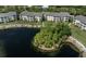 Aerial view of an apartment building complex with a lake and landscaping at 19345 Water Oak Dr # 305, Port Charlotte, FL 33948