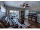 Living room with hardwood floors, leather furniture, and view of bedroom and balcony at 19345 Water Oak Dr # 305, Port Charlotte, FL 33948