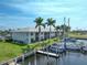Aerial view of waterfront property with boat slips and lush landscaping at 3600 Bal Harbor Blvd # 1G, Punta Gorda, FL 33950
