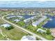 Stunning aerial view of waterfront condos with boat docks, pools, and tennis courts in a beautiful coastal community at 3600 Bal Harbor Blvd # 1G, Punta Gorda, FL 33950