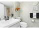 Bathroom with a shower/tub combo, updated vanity, and stylish wallpaper at 3600 Bal Harbor Blvd # 1G, Punta Gorda, FL 33950
