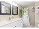 Bathroom with a walk-in shower, double sinks, and updated fixtures at 3600 Bal Harbor Blvd # 1G, Punta Gorda, FL 33950