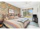Bedroom with a king-size bed, striped bedding, and a view of palm trees at 3600 Bal Harbor Blvd # 1G, Punta Gorda, FL 33950