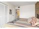 Bedroom with a king-size bed, striped bedding, and access to a bathroom at 3600 Bal Harbor Blvd # 1G, Punta Gorda, FL 33950