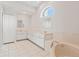 Bathroom with corner bathtub, double vanity, and white cabinets at 3853 Bordeaux Dr, Punta Gorda, FL 33950