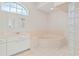 Main bathroom with a bathtub, shower, and white cabinets at 3853 Bordeaux Dr, Punta Gorda, FL 33950