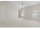 Spacious bedroom with carpeted floor, ceiling fan, and large windows at 3853 Bordeaux Dr, Punta Gorda, FL 33950