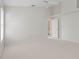 Well-lit bedroom with carpet, ceiling fan and access to bathroom at 3853 Bordeaux Dr, Punta Gorda, FL 33950