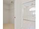 Walk-in closet and bathroom with white cabinets and tile floors at 3853 Bordeaux Dr, Punta Gorda, FL 33950