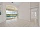 Bright dining room with tile floors and view of pool and golf course at 3853 Bordeaux Dr, Punta Gorda, FL 33950