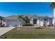House with tile roof, attached garage, and well-manicured lawn at 3853 Bordeaux Dr, Punta Gorda, FL 33950