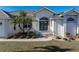 Front view of house with double doors, landscaping, and tile roof at 3853 Bordeaux Dr, Punta Gorda, FL 33950