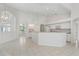 Open kitchen with island, white cabinets, and tile floor at 3853 Bordeaux Dr, Punta Gorda, FL 33950