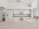 Kitchen boasts white cabinets, tile floors, and a large refrigerator at 3853 Bordeaux Dr, Punta Gorda, FL 33950