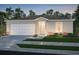 Two-car garage and attractive landscaping enhance the curb appeal of this home at 2096 N San Mateo Dr, North Port, FL 34288