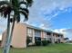 Condo building with balconies, ground level patio, and palm trees at 1354 Rock Dove Ct # A202, Punta Gorda, FL 33950