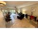 Living room featuring tiled floors, a ceiling fan, and access to a balcony at 1354 Rock Dove Ct # A202, Punta Gorda, FL 33950