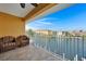 Balcony overlooking the waterfront with seating for two at 1410 Park Beach Cir # 113, Punta Gorda, FL 33950