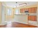 Bright kitchen with wood cabinets, granite countertops, and stainless steel appliances at 17434 Boca Vista Rd # 1006, Punta Gorda, FL 33955
