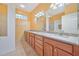 Bathroom with double vanity, granite countertop, and large mirror at 17434 Boca Vista Rd # 1006, Punta Gorda, FL 33955