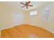 Bedroom with hardwood floors, ceiling fan, and double doors at 17434 Boca Vista Rd # 1006, Punta Gorda, FL 33955