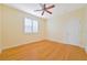 Bright bedroom with ceiling fan, hardwood floors, and window shutters at 17434 Boca Vista Rd # 1006, Punta Gorda, FL 33955