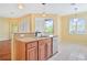 Modern kitchen with island, granite countertops, and stainless steel dishwasher at 17434 Boca Vista Rd # 1006, Punta Gorda, FL 33955