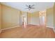Large bedroom with wood floors, ceiling fan and access to other rooms at 17434 Boca Vista Rd # 1006, Punta Gorda, FL 33955