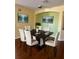 Bright dining room with hardwood floors and a modern dining set at 17434 Boca Vista Rd # 1006, Punta Gorda, FL 33955