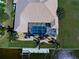 Stunning aerial view of a waterfront home featuring a screened pool, lush landscaping, and a private boat dock at 1429 Blue Jay Ct, Punta Gorda, FL 33950