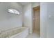 Bathroom featuring marble encased tub and separate walk-in shower at 1429 Blue Jay Ct, Punta Gorda, FL 33950