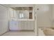Bright bathroom with a double sink vanity, large mirror, and a marble encased tub at 1429 Blue Jay Ct, Punta Gorda, FL 33950