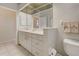 Bathroom featuring a sink, toilet, and large mirror at 1429 Blue Jay Ct, Punta Gorda, FL 33950
